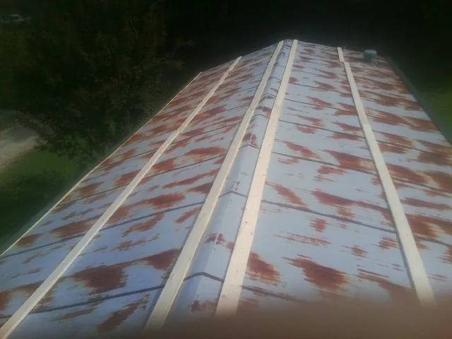 Rusted metal roof panels with new wood purlins before replacement — Storm Damage Roof Repair in Homedale by Roofing Brothers